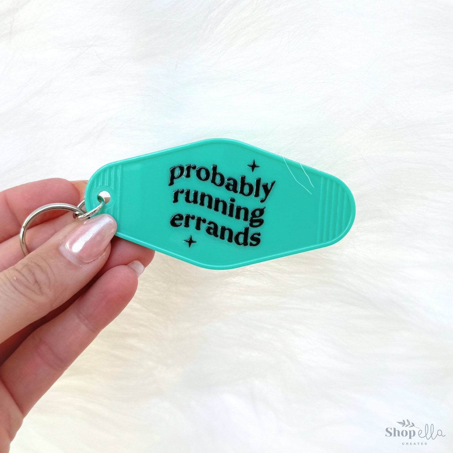 a person holding a keychain that says probably running errands