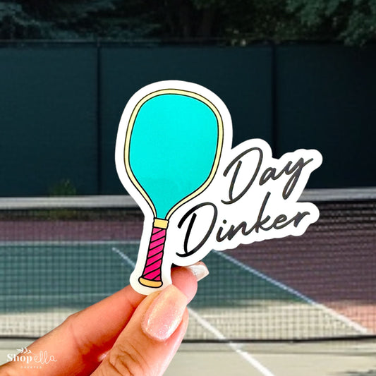 a hand holding a sticker with a tennis racket on it