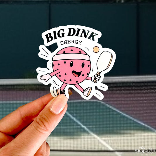 a hand holding up a sticker with a tennis ball and racket on it