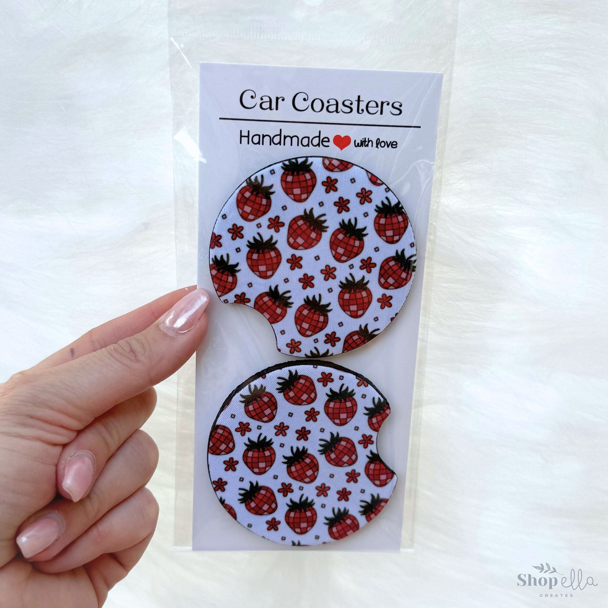 a package of two magnets with strawberries on them