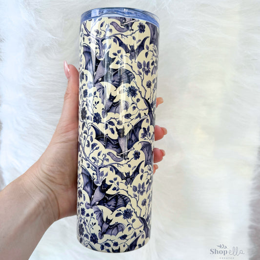 a hand holding a blue and white ceramic cup