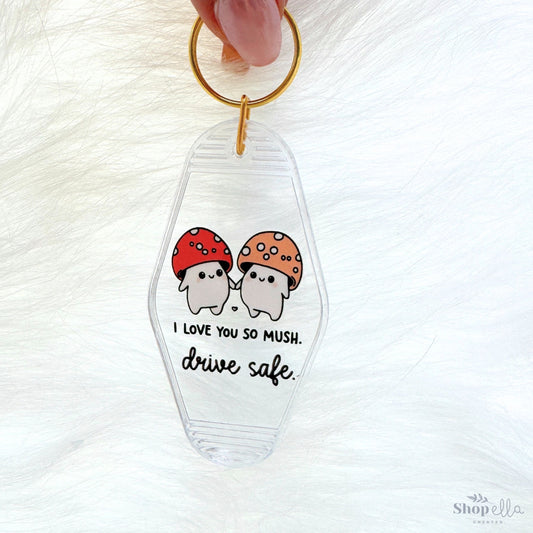 a keychain with a picture of two mushrooms on it saying i love you so mush drive safe