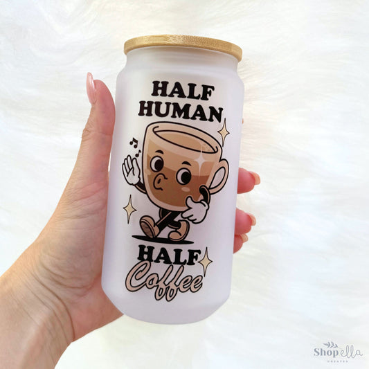 Half Human Half Coffee Glass Cup 18oz a hand holding a coffee can with a cartoon character on it