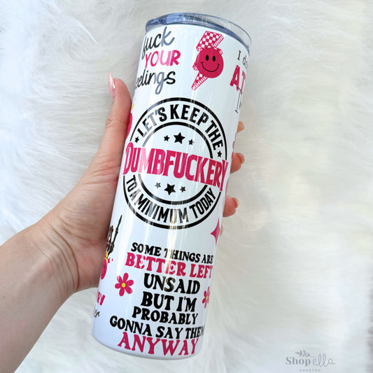 a hand holding a white tumbler cup with pink and black designs