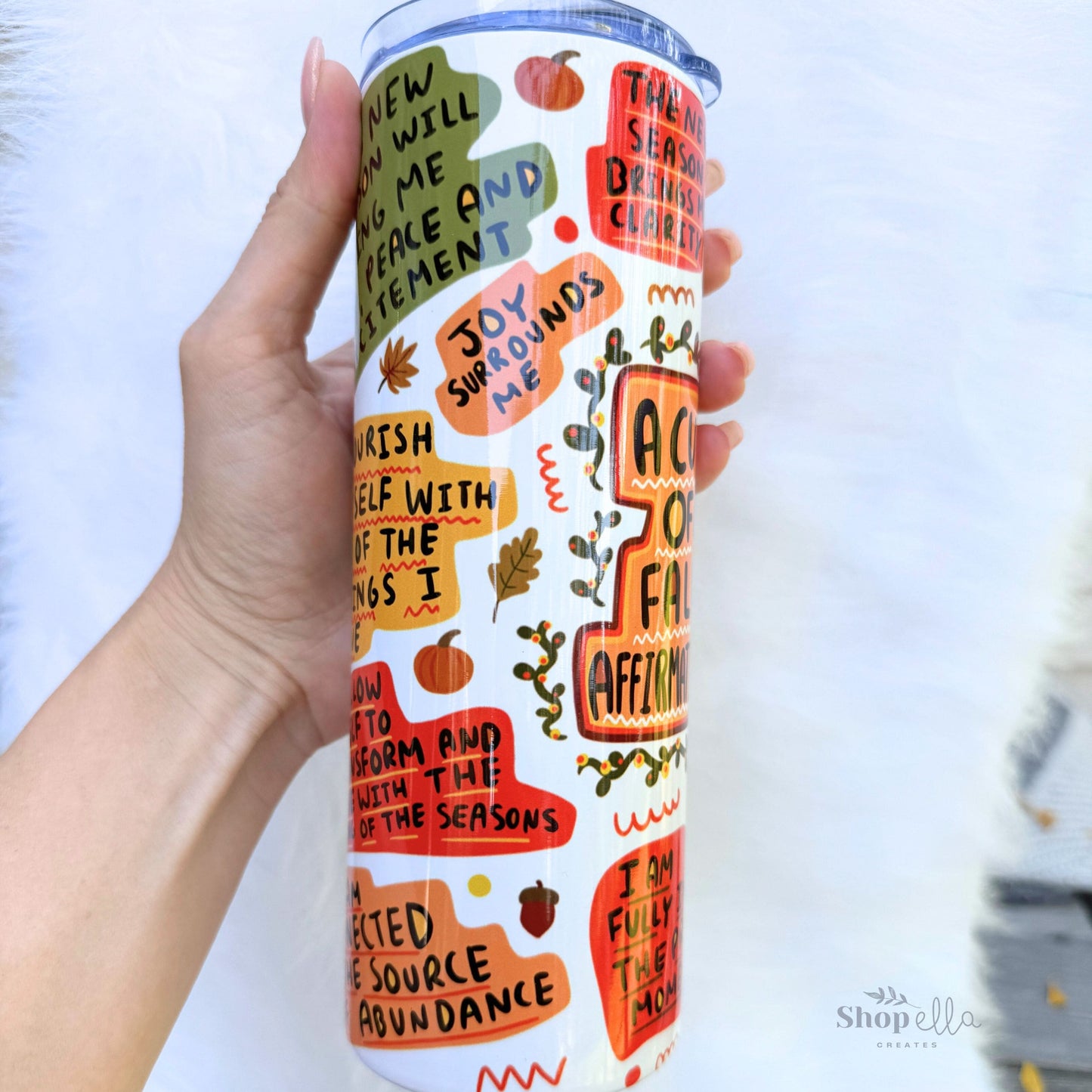 a hand holding a white 20oz skinny tumbler with lid a cup of fall affirmations